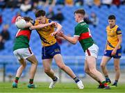 24 May 2024; Shay McGuinness of Roscommon in action against Mark Sheeran, left, and Daithí Butler of Mayo during the Connacht GAA Football Minor Championship final match between Mayo and Roscommon at Dr Hyde Park in Roscommon. Photo by Stephen Marken/Sportsfile
