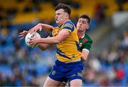 24 May 2024; Shay McGuinness of Roscommon in action against Daithí Butler of Mayo during the Connacht GAA Football Minor Championship final match between Mayo and Roscommon at Dr Hyde Park in Roscommon. Photo by Stephen Marken/Sportsfile