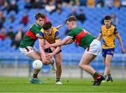 24 May 2024; Shay McGuinness of Roscommon in action against Mark Sheeran, left, and Daithí Butler of Mayo during the Connacht GAA Football Minor Championship final match between Mayo and Roscommon at Dr Hyde Park in Roscommon. Photo by Stephen Marken/Sportsfile