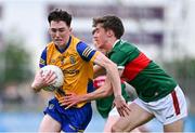 24 May 2024; Eoin Collins of Roscommon in action against Josh Moyles of Mayo during the Connacht GAA Football Minor Championship final match between Mayo and Roscommon at Dr Hyde Park in Roscommon. Photo by Stephen Marken/Sportsfile