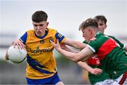 24 May 2024; Dean Casey of Roscommon in action against Tom Hession of Mayo during the Connacht GAA Football Minor Championship final match between Mayo and Roscommon at Dr Hyde Park in Roscommon. Photo by Stephen Marken/Sportsfile