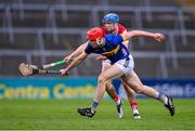 24 May 2024; Cathal English of Tipperary is tackled by Diarmuid Healy of Cork during the oneills.com Munster GAA U20 Hurling Championship final match between Tipperary and Cork at TUS Gaelic Grounds in Limerick. Photo by Ben McShane/Sportsfile
