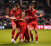24 May 2024; Will Jarvis of Shelbourne celebrates with team-mates Evan Caffrey, left, and Tyreke Wilson, right, after scoring his side's second goal during the SSE Airtricity Men's Premier Division match between Shamrock Rovers and Shelbourne at Tallaght Stadium in Dublin. Photo by Stephen McCarthy/Sportsfile