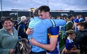 24 May 2024; Adam Daly of Tipperary celebrates with a supporter after the oneills.com Munster GAA U20 Hurling Championship final match between Tipperary and Cork at TUS Gaelic Grounds in Limerick. Photo by Ben McShane/Sportsfile