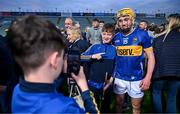 24 May 2024; Senan Butler of Tipperary stands for a photo with a supporter after the oneills.com Munster GAA U20 Hurling Championship final match between Tipperary and Cork at TUS Gaelic Grounds in Limerick. Photo by Ben McShane/Sportsfile