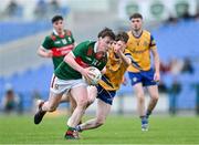 24 May 2024; Oisin Deane of Mayo in action against Liam Finneran of Roscommon during the Connacht GAA Football Minor Championship final match between Mayo and Roscommon at Dr Hyde Park in Roscommon. Photo by Stephen Marken/Sportsfile