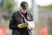 25 May 2024; Armagh manager Kieran McGeeney studies the programme before the GAA Football All-Ireland Senior Championship Round 1 match between Armagh and Westmeath at the Box It Athletic Grounds in Armagh. Photo by Ben McShane/Sportsfile