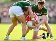 25 May 2024; Ryan Burns of Louth in action against Ronan Jones, left, and Adam O'Neill of Meath during the GAA Football All-Ireland Senior Championship Round 1 match between Louth and Meath at Grattan Park in Inniskeen, Monaghan. Photo by Daire Brennan/Sportsfile