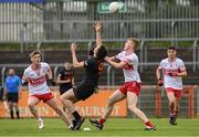 26 May 2024; Daithi O'Callaghan of Armagh in action against Cathal O'Mianain of Derry during the Electric Ireland Ulster GAA Football Minor Championship final match between Armagh and Derry at O'Neill's Healy Park in Omagh, Tyrone. Photo by Philip Fitzpatrick/Sportsfile