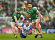 26 May 2024; Calum Lyons of Waterford is tackled by Will O Donoghue, left, and Cathal O Neill of Limerick during the Munster GAA Hurling Senior Championship Round 5 match between Limerick and Waterford at TUS Gaelic Grounds in Limerick Photo by Tom Beary/Sportsfile