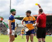 26 May 2024; Referee Johnny Murphy shows a yellow card to both Tony Kelly of Clare, and Noel McGrath of Tipperary during the Munster GAA Hurling Senior Championship Round 5 match between Tipperary and Clare at FBD Semple Stadium in Thurles, Tipperary. Photo by Michael P Ryan/Sportsfile
