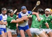 26 May 2024; Darragh Lyons of Waterford is tackled by Gearóid Hegarty, left, and Conor Boylan of Limerick during the Munster GAA Hurling Senior Championship Round 5 match between Limerick and Waterford at TUS Gaelic Grounds in Limerick Photo by Tom Beary/Sportsfile