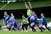 29 May 2024; Marshalstown NS, Wexford, players and coaches celebrate after winning a play-off match on penalties in the finals of the girls B cup, for medium schools, during the FAI Primary 5s Finals day at Aviva Stadium in Dublin. Photo by Stephen McCarthy/Sportsfile