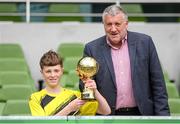 29 May 2024; Oisín Ó hÍr of Gaelscoil Cois Feabhail, Craigtown, Donegal, is presented with the section A, for small sized schools, player of the tournament award by FAI president Paul Cooke during the FAI Primary 5s Finals day at Aviva Stadium in Dublin. Photo by Stephen McCarthy/Sportsfile