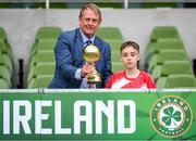 29 May 2024; Tom Ó Caoimh of Gaelscoil Choinn tSáile, Cork, is presented with the section B, for mixed medium sized schools, player of the tournament award by FAI board member Nixon Morton during the FAI Primary 5s Finals day at Aviva Stadium in Dublin. Photo by Stephen McCarthy/Sportsfile