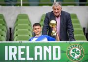 29 May 2024; Patrick Toth of St Declan’s NS, Ashbourne, Meath, is presented with the section C, for mixed large sized schools, player of the tournament award by FAI president Paul Cooke during the FAI Primary 5s Finals day at Aviva Stadium in Dublin. Photo by Stephen McCarthy/Sportsfile