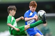 29 May 2024; Adam Lohan of Windfield NS, Galway, left, in action against Hugh Fynes of Scoil Moibhi, Dublin, in their section A cup, for mixed small sized schools, match during the FAI Primary 5s Finals day at Aviva Stadium in Dublin. Photo by Stephen McCarthy/Sportsfile