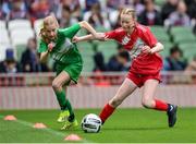 29 May 2024; Violet O’Malley of Scoil Phádraig, Westport, Mayo, in action against Méabh O’Connor of Burnfort NS, Cork, right, during the FAI Primary 5s Finals day at Aviva Stadium in Dublin. Photo by Stephen McCarthy/Sportsfile