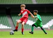 29 May 2024; Stiofán Barlow of Gaelscoil Choinn tSáile, Cork, in action against Mounir Soufan of Scoil Phádraig, Westport, Mayo, right, during the FAI Primary 5s Finals day at Aviva Stadium in Dublin. Photo by Stephen McCarthy/Sportsfile