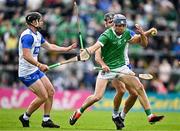 26 May 2024; David Reidy of Limerick in action against Ian Kenny, left, and Mark Fitzgerald of Waterford during the Munster GAA Hurling Senior Championship Round 5 match between Limerick and Waterford at TUS Gaelic Grounds in Limerick. Photo by Sam Barnes/Sportsfile