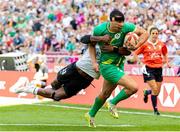 1 June 2024; Jordan Conroy of Ireland is tackled by Joni Nasova of Fiji during the HSBC Men's SVNS 2024 Grand Finals Pool B match between Ireland and Fiji at Civitas Metropolitano Stadium in Madrid, Spain. Photo by Juan Gasparini/Sportsfile