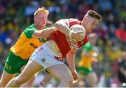 1 June 2024; Kevin Flahive of Cork in action against Oisin Gallen of Donegal during the GAA Football All-Ireland Senior Championship Round 2 match between Cork and Donegal at Páirc Uí Rinn in Cork. Photo by Matt Browne/Sportsfile