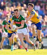 1 June 2024; Eoghan McLaughlin of Mayo is tackled by Daire Cregg of Roscommon during the GAA Football All-Ireland Senior Championship Round 2 match between Roscommon and Mayo at Dr Hyde Park in Roscommon. Photo by Ben McShane/Sportsfile