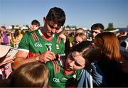 1 June 2024; Tommy Conroy of Mayo signs autographs for supporters after the GAA Football All-Ireland Senior Championship Round 2 match between Roscommon and Mayo at Dr Hyde Park in Roscommon. Photo by Ben McShane/Sportsfile