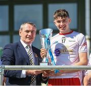 1 June 2024; Ciaran McLaughlin GAA vice President present the Electric Ireland Corn Jerome O'Leary Celtic Challenge trophy to Cillian Earley of Tyrone after the Electric Ireland Corn Jerome O'Leary Celtic Challenge final match between Tyrone and Sligo at Fr Tierney Park in Ballyshannon, Donegal. Photo by Oliver McVeigh/Sportsfile