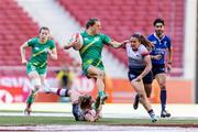 2 June 2024; Béibhinn Parsons of Ireland in action against Amy Wilson Hardy, left, and Kayleigh Powell of Great Britain during the HSBC Women's SVNS 2024 Grand Finals play-off match between Ireland and Great Britain at Civitas Metropolitano Stadium in Madrid, Spain. Photo by Juan Gasparini/Sportsfile