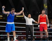 2 June 2024; Davit Chaloyan of Armenia, left, is declared victorious against Martin McDonagh of Ireland, after their Men's +92kg Finals at the Paris 2024 Olympic Boxing Qualification Tournament at Hua Mak Indoor Stadium in Bangkok, Thailand. Photo by Joe Walsh/Sportsfile