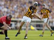 31 July 2004; John Hoyne, Kilkenny, shoots for a point as referee Pat Horan takes cover. Guinness All-Ireland Hurling Championship Quarter Final Replay, Clare v Kilkenny, Semple Stadium, Thurles, Co. Tipperary. Picture credit; Brendan Moran / SPORTSFILE