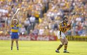 31 July 2004; DJ Carey, Kilkenny, takes a free as Clare's James O'Connor looks on. Guinness All-Ireland Hurling Championship Quarter Final Replay, Clare v Kilkenny, Semple Stadium, Thurles, Co. Tipperary. Picture credit; Brendan Moran / SPORTSFILE