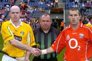 25 July 2004; Colm McGuckian, Antrim captain, and Ben O'Connor, Cork captain, shake hands in the company of Referee Aodan MacSuibhne. Guinness All-Ireland Senior Hurling Championship, Quarter Final, Antrim v Cork, Croke Park, Dublin. Picture credit; Brian Lawless / SPORTSFILE