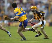 31 July 2004; James ' Cha ' Fitzpatrick, Kilkenny, in action against Brian Quinn, Clare. Guinness All-Ireland Hurling Championship Quarter Final Replay, Clare v Kilkenny, Semple Stadium, Thurles, Co. Tipperary. Picture credit; Brendan Moran / SPORTSFILE