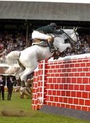 7 August 2004; Ireland's Cian O'Connor on Ortwin De Laubry jumps the wall during the Land Rover Puissance. Dublin Horse Show, Main Arena, RDS, Dublin. Picture credit; Matt Browne / SPORTSFILE