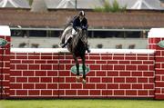 7 August 2004; Christian Hermon, France, on Ephebe For Ever Ecolit, jumps the wall during the Land Rover Puissance. Dublin Horse Show, Main Arena, RDS, Dublin. Picture credit; Matt Browne / SPORTSFILE