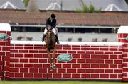7 August 2004; Patrice Delaveau, France, on Ideal Breceen, jumps the wall during the Land Rover Puissance. Dublin Horse Show, Main Arena, RDS, Dublin. Picture credit; Matt Browne / SPORTSFILE