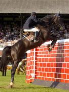 7 August 2004; Christian Hermon, France, on Ephebe For Ever Ecolit, jumps the wall during the Land Rover Puissance. Dublin Horse Show, Main Arena, RDS, Dublin. Picture credit; Matt Browne / SPORTSFILE