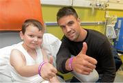 18 September 2013; Munster and Ireland Rugby star Conor Murray made a special visit to Temple Street Children’s University Hospital, as part of Temple Street’s 'Kiss Them Better' campaign. On the visit to the hospital Conor urged Irish families to buy Medicare plasters to support Temple Street. For every pack of Medicare plasters bought from pharmacies throughout the country, the Limerick based first-aid company will make a donation to the hospital's emergency equipment fund. Check out www.kissthembetter.ie for more information. Pictured with Conor Murray during the visit is Luke Concannon, age 8, from Lucan, Co. Dublin. Temple Street Children's University Hospital, Temple Street, Dublin. Picture credit: Stephen McCarthy / SPORTSFILE