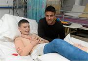 18 September 2013; Munster and Ireland Rugby star Conor Murray made a special visit to Temple Street Children’s University Hospital, as part of Temple Street’s 'Kiss Them Better' campaign. On the visit to the hospital Conor urged Irish families to buy Medicare plasters to support Temple Street. For every pack of Medicare plasters bought from pharmacies throughout the country, the Limerick based first-aid company will make a donation to the hospital's emergency equipment fund. Check out www.kissthembetter.ie for more information. Pictured with Conor Murray during the visit is Cian Kavanagh, age 15, Duleek, Co. Meath. Temple Street Children's University Hospital, Temple Street, Dublin. Picture credit: Stephen McCarthy / SPORTSFILE