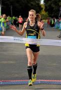 21 September 2013; Maria McCambridge crosses the finish line to win the half-marathon Airtricity Dublin race series. Phoenix Park, Dublin. Picture credit: Pat Murphy / SPORTSFILE
