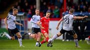 7 June 2024; Liam Burt of Shelbourne in action against Dundalk players Paul Doyle, left, and John Mountney during the SSE Airtricity Men's Premier Division match between Shelbourne and Dundalk at Tolka Park in Dublin. Photo by Seb Daly/Sportsfile