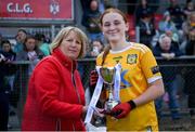 8 June 2024; Antrim captain Ella McLaughlin receives the trophy from Westmeath LGFA chairperson, Geraldine Giles, following the 2024 All-Ireland U14 Bronze Final between Limerick and Antrim at Coralstown Kinnegad GAA Club in Kinnegad, Westmeath. Photo by Shauna Clinton/Sportsfile
