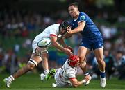 8 June 2024; James Lowe of Leinster is tackled by Greg Jones and Mike Lowry of Ulster during the United Rugby Championship quarter-final match between Leinster and Ulster at the Aviva Stadium in Dublin. Photo by Harry Murphy/Sportsfile