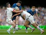 8 June 2024; Robbie Henshaw of Leinster is tackled by John Cooney and Stewart Moore of Ulster during the United Rugby Championship quarter-final match between Leinster and Ulster at the Aviva Stadium in Dublin. Photo by Harry Murphy/Sportsfile
