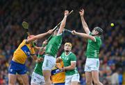 9 June 2024; Peter Duggan of Clare and Mike Casey and Diarmaid Byrnes of Limerick all miss the dropping sliotar during the Munster GAA Hurling Senior Championship final match between Clare and Limerick at FBD Semple Stadium in Thurles, Tipperary. Photo by Ray McManus/Sportsfile