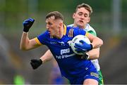 15 June 2024; Emmet McMahon of Clare is tackled by Hugh McFadden of Donegal during the GAA Football All-Ireland Senior Championship Round 3 match between Clare and Donegal at Hastings Insurance MacHale Park in Castlebar, Mayo. Photo by Ben McShane/Sportsfile