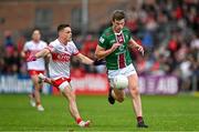 15 June 2024; John Heslin of Westmeath in action against Eunan Mulholland of Derry during the GAA Football All-Ireland Senior Championship Round 3 match between Derry and Westmeath at Páirc Esler in Newry, Down. Photo by Sam Barnes/Sportsfile