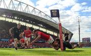 15 June 2024; Antoine Frisch of Munster scores his side's first try despite the efforts of Sebastian Cancelliere of Glasgow Warriors during the United Rugby Championship semi-final match between Munster and Glasgow Warriors at Thomond Park in Limerick. Photo by Brendan Moran/Sportsfile
